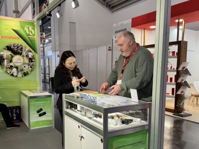 jb Capacitors representative discussing capacitor selection and application requirements with a visitor in Munich at electronica 2024