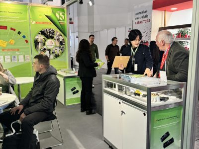 jb Capacitors staff interacting with business partners at the exhibition counter during electronica 2024 Munich