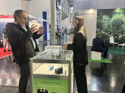 jb Capacitors representative presenting electronic components and capacitor solutions to a trade visitor at electronica 2024